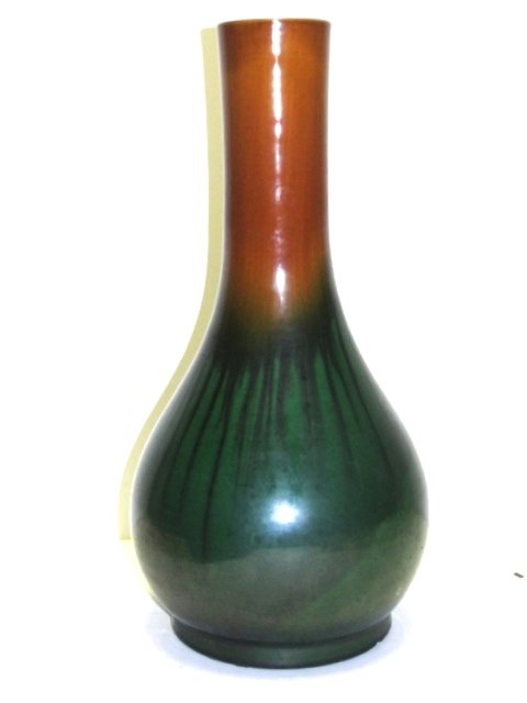 Japanese Studio Pottery High Glaze Vessel: Bulbous bottle form vessel with spot at bottom possibly for spout. Flat top neck in a brown tone glaze tampering into a deep green high glaze bottom half with long slender lines of a darker color. Con