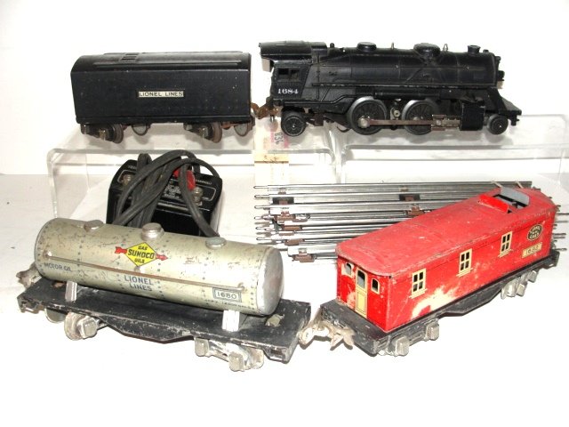 Lionel Train Set Cast Iron Engine 3 Tin Cars: With transformer and track in working order. Condition used.