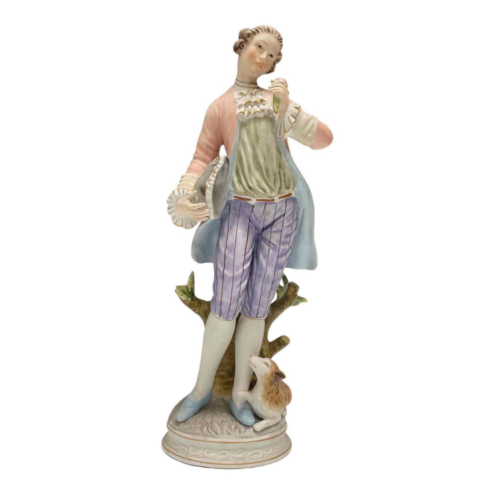 Bisque Porcelain Figurine of Young Man with Dog on Base: Marked with crossed red dyed arrows and standing approx 14" tall. Good overall age appropriate condition, see photos.