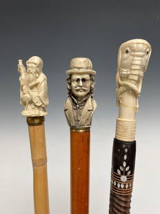 Lot of Three Canes with Handcarved Toppers: Carved Composition depicting gentleman man wearing top hat measuring approx 34" tall 2) Thai or Asian Elephant topper cane with inlaid Mother of Pearl accents throughout shaft. 37" tall ( tusks appear