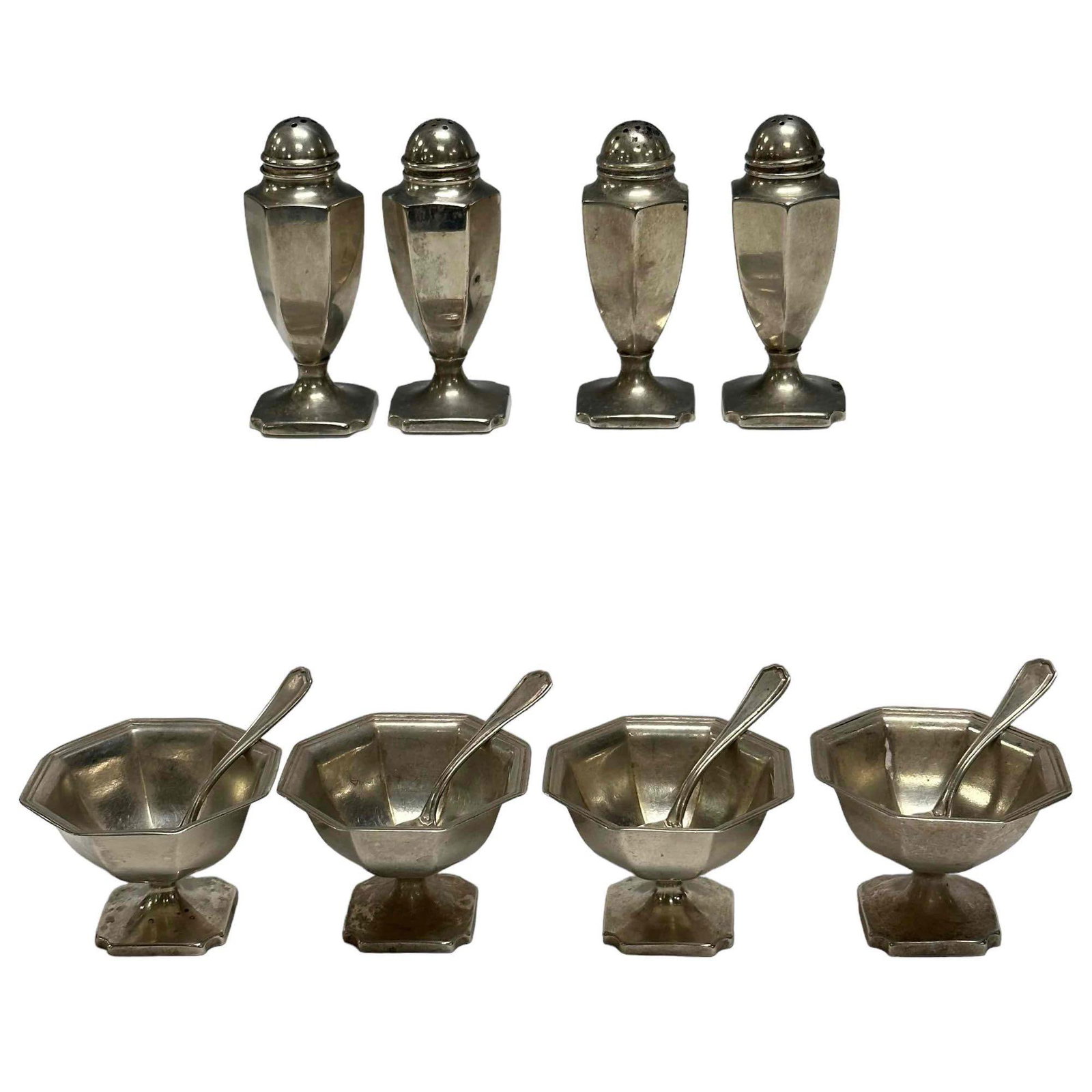 (4) Early Reed and Barton Sterling Personal Salts & Peppers: Truly a taste of elegance for your dinner parties. Comprising of four pedestal sterling silver octagonal personal salts with sterling spoons stamped on bottom 147 pattern number approx 1.5" tall x 2"