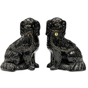 Pair of 19th Century Staffordshire Black Spaniel Porcelain Dogs: Pair of Staffordshire black with gold trim porcelain spaniel dog figurines. Having retail store tags from antique shop in London. Measuring approx. 9.25" tall. In good condition with no noted cracks o