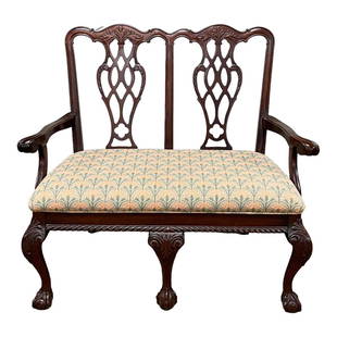 20th C. Mahogany Chippendale Style Ball and Claw Settee: Petite double settle with pierced carved back on ball and claw feet, mid 20th century. Measuring approx 39" high x 43" wide x 21" deep. Overall condition is good. Normal use and wear.