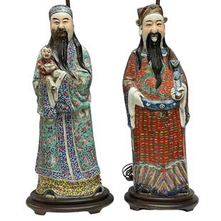 Early 19th Century Chinese Porcelain Gods Fu and Lu Figurines: Two early 20th century polychrome Chinese Gods Fu and Lu in the famille rose palette. Both mounted on wooden lamp bases with lamp post separate from figurines. Measuring approx. 18.75" tall figures an