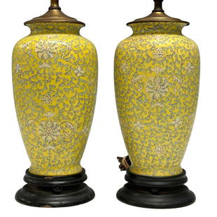 Chinese Export Famille Jaune Porcelain Vase Lamps: A fine enameled pair of Chinese export lamps on ebonized cylindrical bases. Early 19th century, later fitted into lamps as shown, see photos. Off white flowers with mint green ivy foliage over Famille