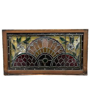 Antique Leaded and Stained Glass Window: Early 20th century leaded and stained glass window with flowers and center arch resembling a peacock. A few imperfections (cracks) and warping which is normal use and wear as shown. Still in original