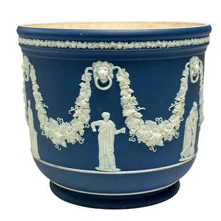 WEDGWOOD Cobalt Blue Jasperware Jardiniere: A fine late 19th century or just turn of the 20th century Wedgwood biscuit porcelain planter in it's traditional cobalt blue and white jasper color featuring Roman figures along the body, impressed ma