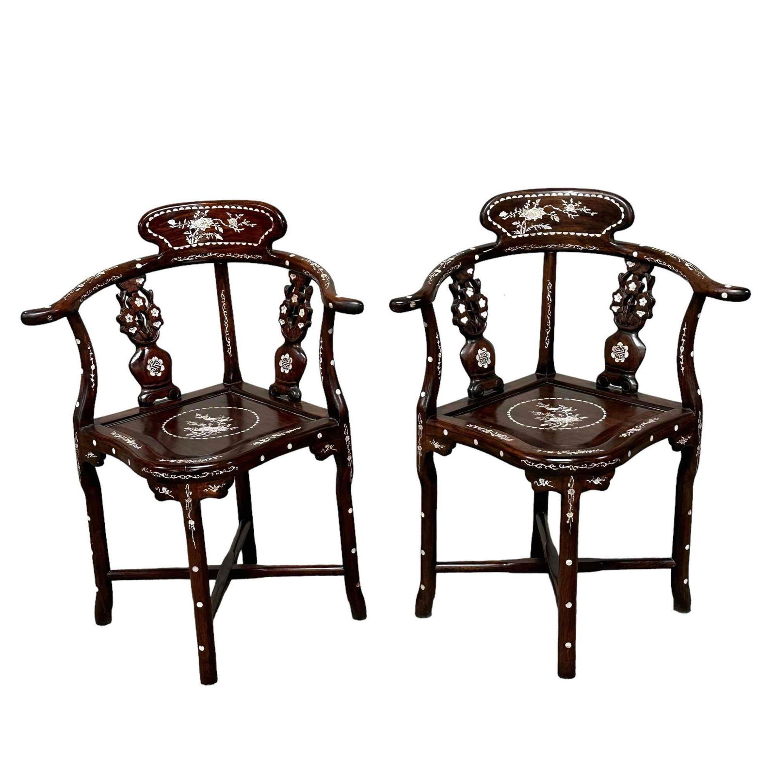 Pair of Chinese Rosewood Corner Chairs w/ MOP inlaid: A fine pair of 20th century Chinese rosewood corner chairs with mother of pearl inlaid with flowers and bird motif and urn planter style slit back as shown, see photos. Measuring approx 32.5"Hx28"x21.