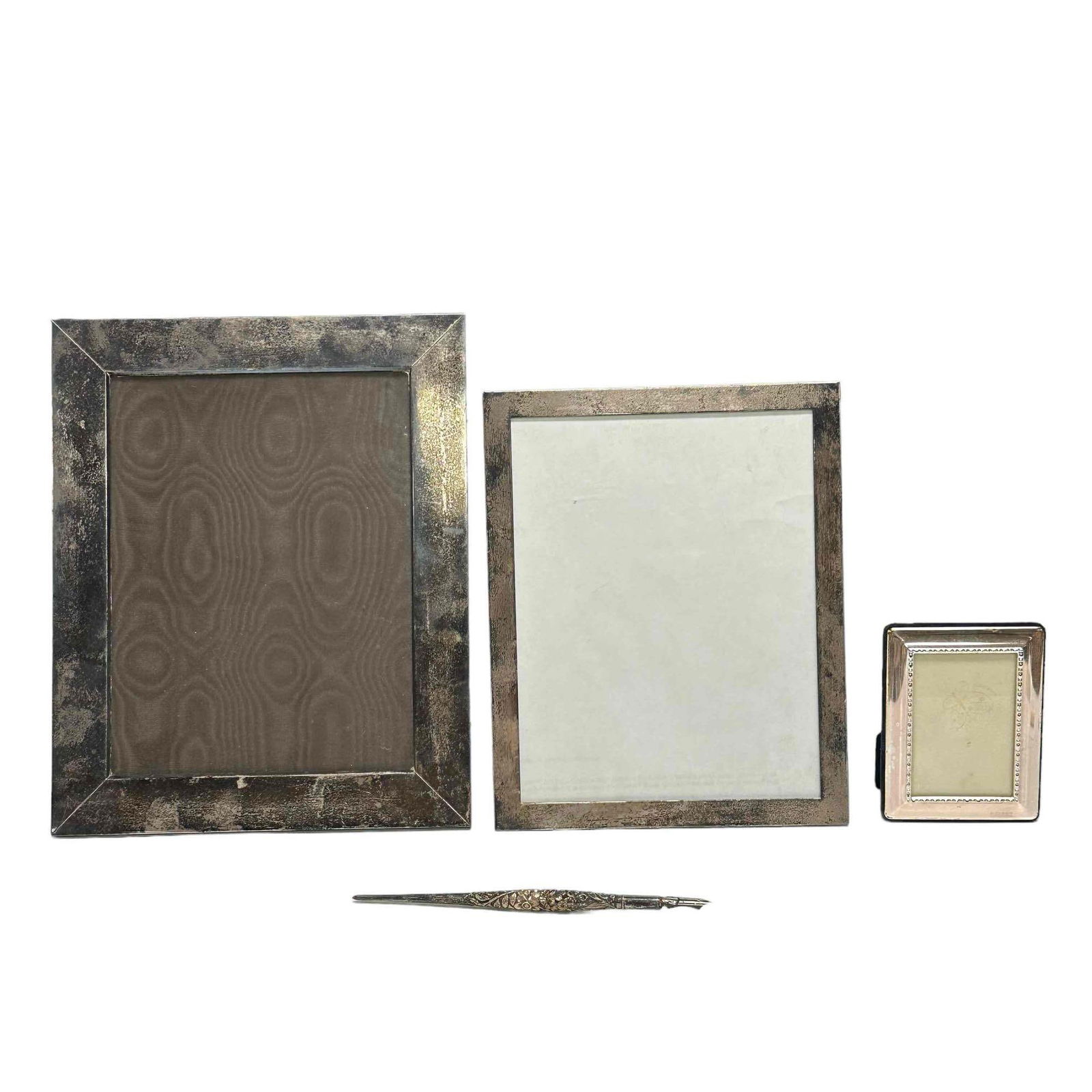 Sterling Silver Frames and Calligraphy Dip Ink Pen: A fine repousse sterling silver dip ink fountain pen approx 8" long and three sterling photo frames. Largest frame is approx 12" x 10" overall (both take 8x10) and smaller is marked .925 approx 5" x 3