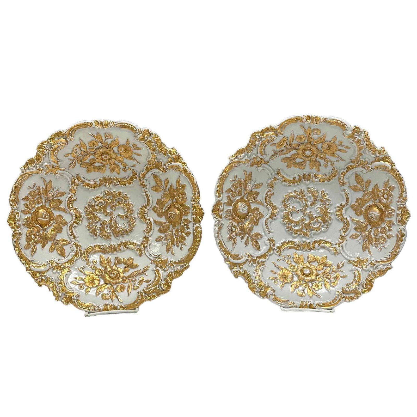 Pair (2) of German MEISSEN Partial Gilt Plates: Pair of decorative 19th century plates with relief decoration of floral bouquets and with gilt frame of rocaille and flowers made by Meissen, model designed by Ernst August Leuteritz, marked on verso 