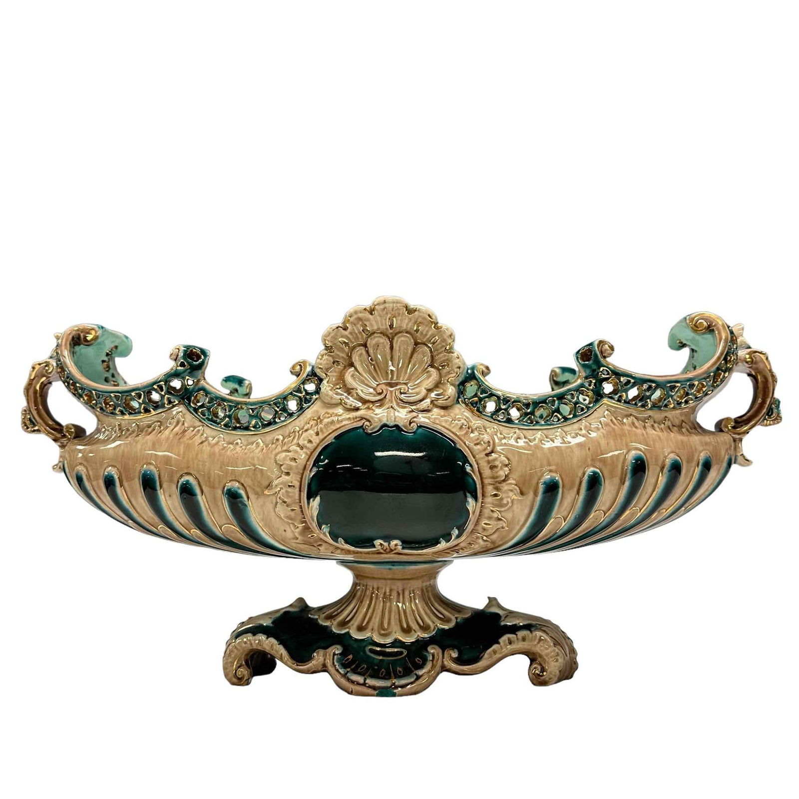 Victorian Majolica Pedestal Centerpiece: 19th century Victorian era majolica pedestal centerpiece bowl. Great emerald green and beige coloring with gold accents. Measuring approx. 19" long x 8.5" tall. In good condition with chipped handle p