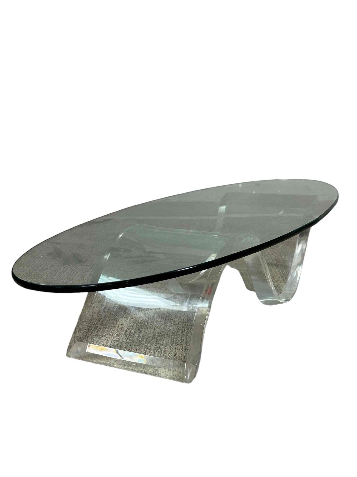 Mid Century Modern Lucite and Glass Cocktail Table: Lucite serpentine base with thick tapered oval beveled top. Measuring approx 5ft long x 20" deep. Light use and wear, overall very good as shown. Glass can sit either way as the photos display. Great