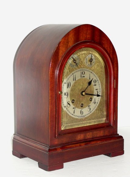 German Made Mahogany Clock With Chimes: Condition very good, in working order. Stamped Made In Germany # 2370283. Condition very good and in working order. H. 14'' W. 10'' D. 8''