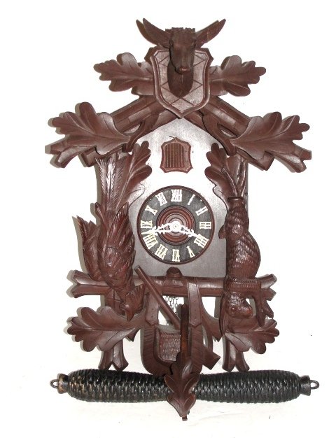 Carved German Coo Coo Clock Mid 20th. C.: Having dead game figures of deer, rabbit and bird. Condition over all very good, deer missing horns, top section reglued at one point. H. 20'' W. 12''