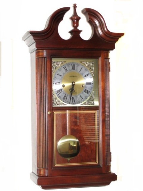 Howard Miller Wall Hanging Clock: Appears to be Mahogany or Cherry wood. Condition very good, running now. All Clocks Sold As Is.