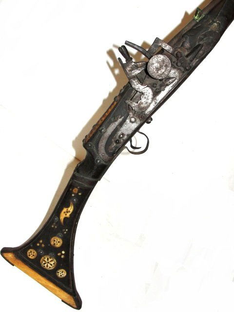 19th C. Moroccan Rifle With Camel Bone Inlay: Typical North African (Moroccan), North African Mukahla musket, molded and simply carved, hardwood, full stock with a wide and flared, curved, flat, triangular butt with nicely walrus ivory? or camel