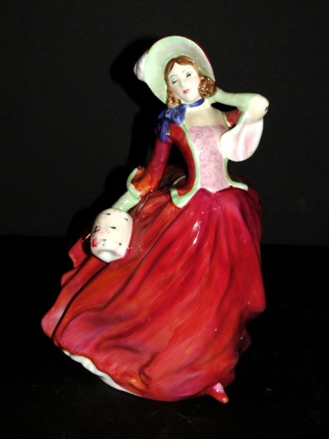 Royal Doulton Figurine Autumn Breezes: HN. 1934. Long flowing red dress , white muff pink bodice and green/ brown hat . Condition very good. 7 1/2''