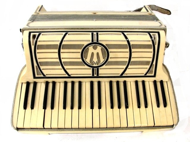 Art Deco Style Accordion With Case: Condition used, needs cleaning, couple keys not working, case worn. Has the letter M in speaker area.