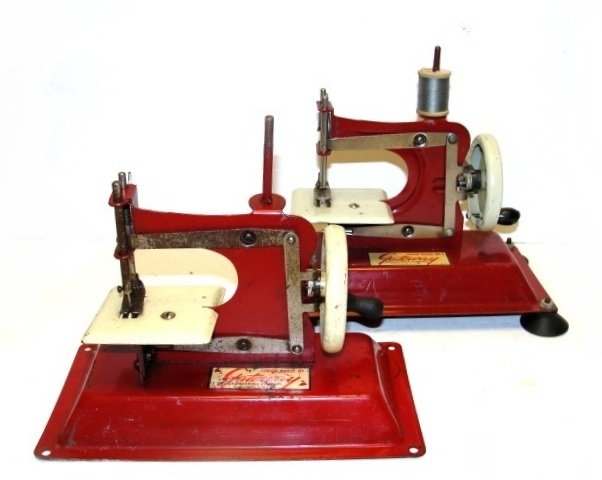 Two Gateway Childs Metal Sewing Machines: Toy Sewing Machine manufactured by Gateway Engineering Co. of Chicago. It is in exceptional working condition and I think all of the moving parts are intact, solid Red with the sewing platform and the