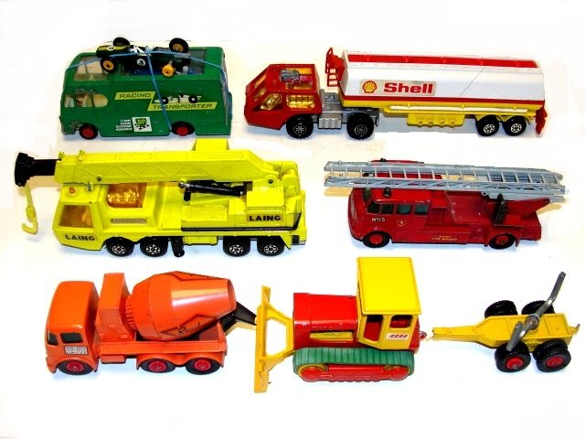 Collection Lisney Match Box Trucks England: Including fire truck& heavy crane truck with movable ladders, cement truck, Shell Gas Hauler, BP race car transportation truck with 2 cars inside and extra car, bull Dozier, and log trailer. Condition