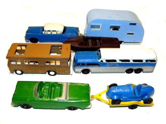 Collection Of Metal & Plastic Tootsie Toy Cars: Including plastic camper missing door, plastic boat with metal trailer, 3 metal cars with one trailer, metal mobile home and unsigned greyhound Bus. Condition overall good, used toys.