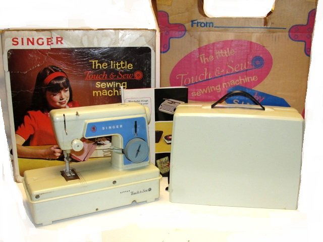 The Little Touch & Sew Toy Sewing Machine: Singer 1966 The Little Touch & Sew Toy Sewing Machine, battery Op. with original case, box and slip over advertizing cover. Condition very good, box has torn edge's as does cover .
