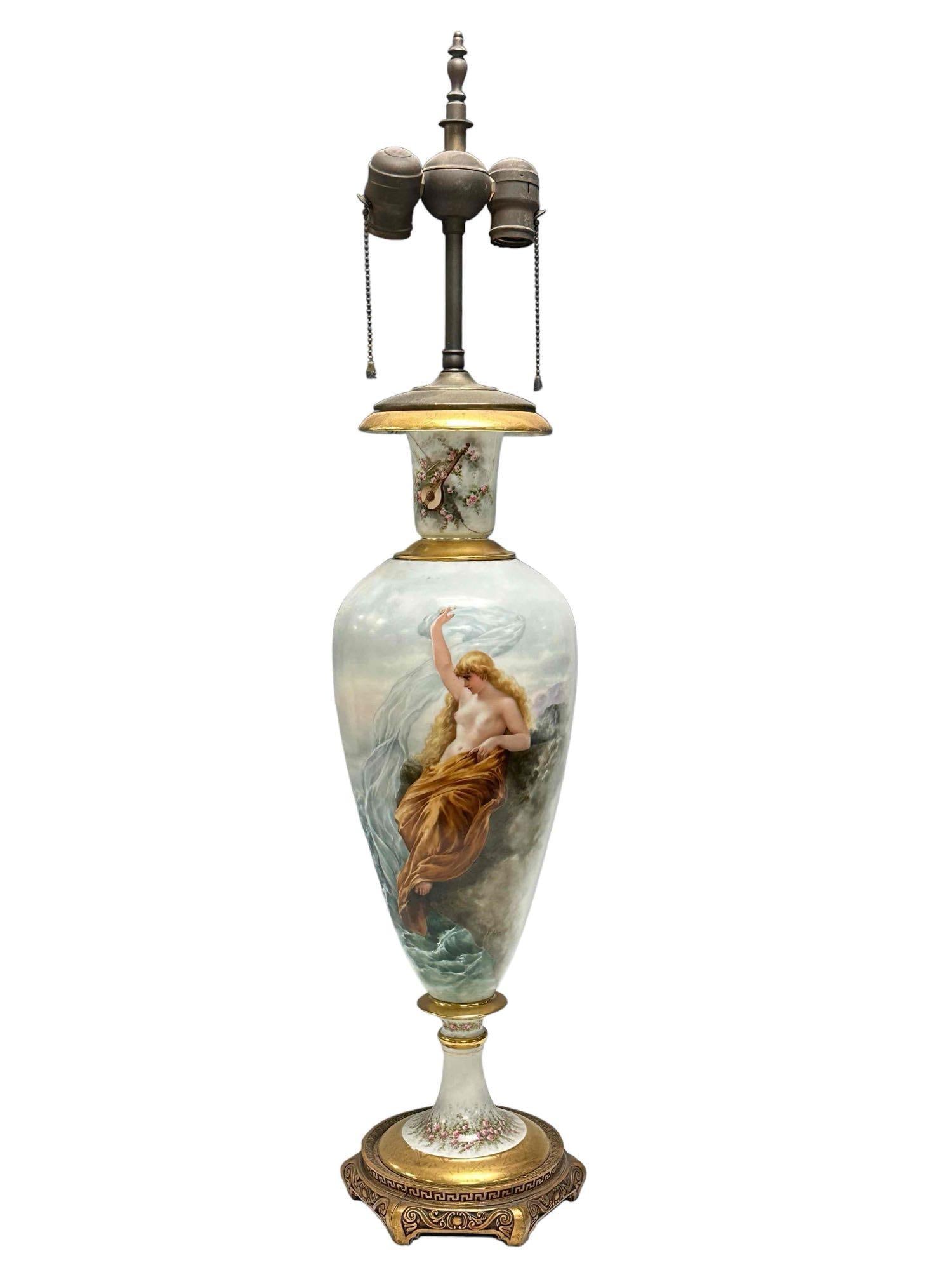 Artist Signed F. Kuhn Semi Nude Porcelain Urn Lamp: Signed porcelain urn form lamp with semi nude woman as shown. Measuring approx 34" tall. Has repairs and damage as shown, but a wonderful display and painting of semi nude elegant woman. See photos