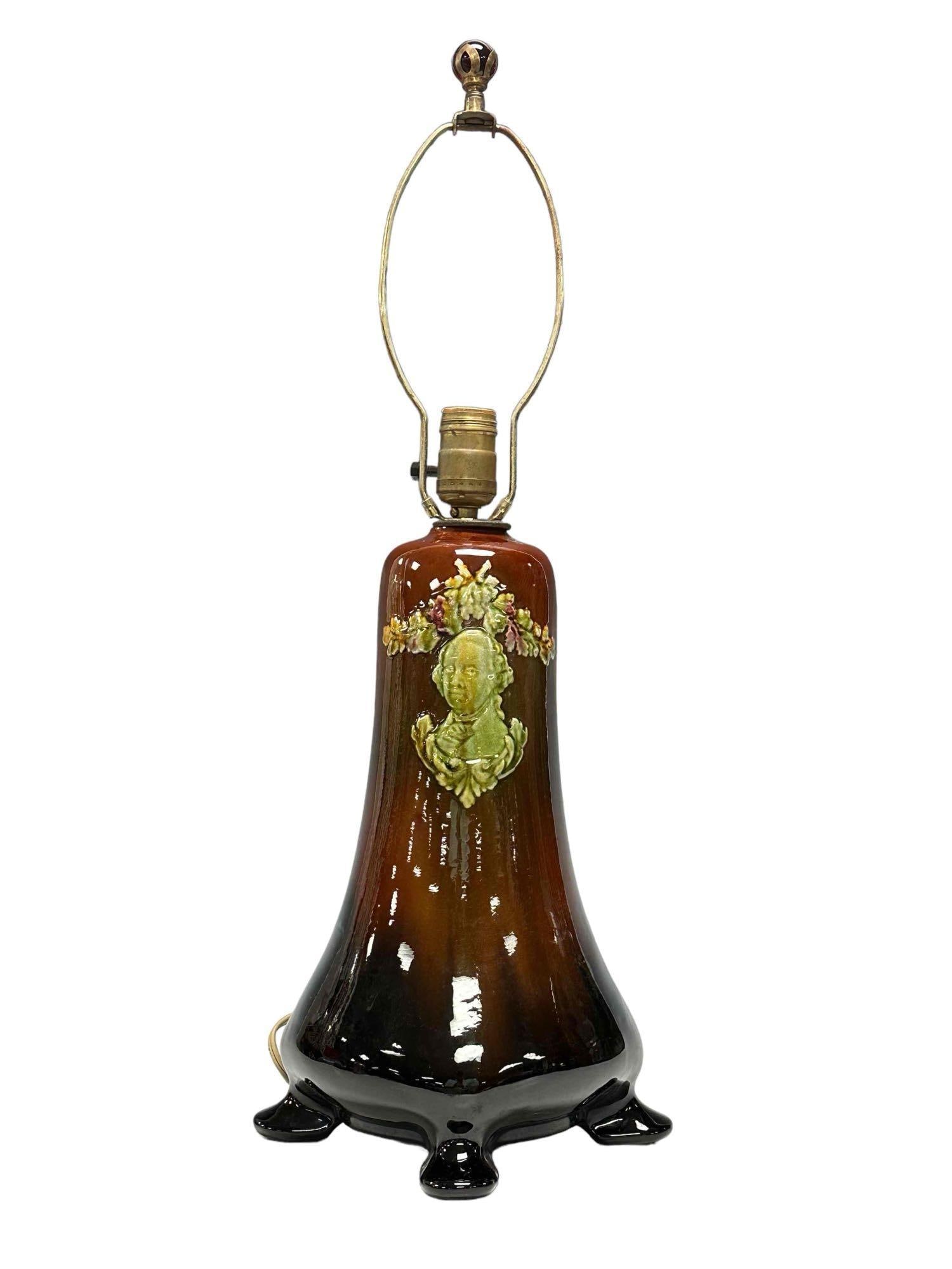 Weller LOUWELSA Presidential Pottery Lamp: A Weller pottery footed lamp with George Washington raised relief portrait. Measuring approx 25" tall to the harp. Good condition as shown, see photos for details.