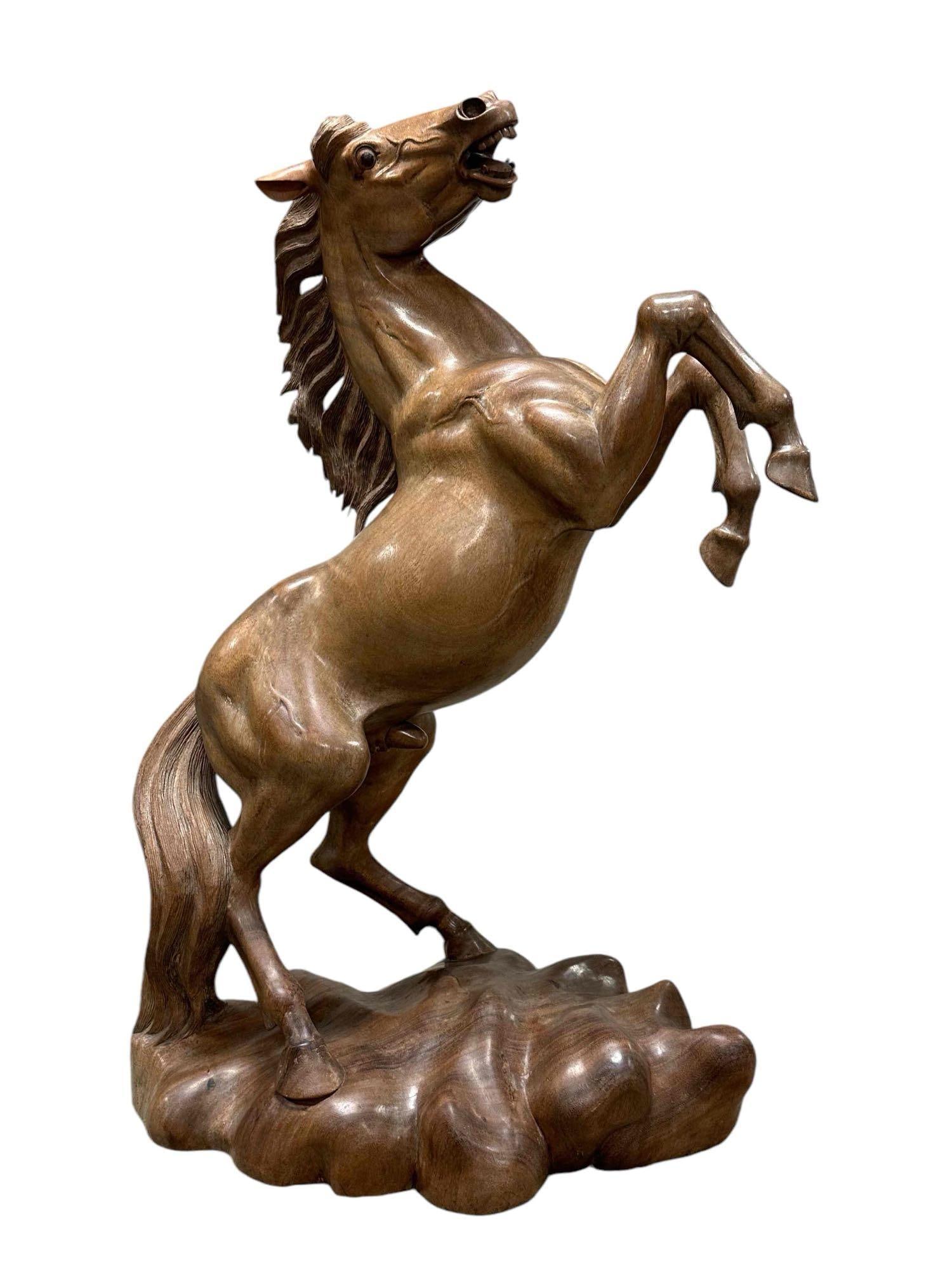 Signed Balinese Style Carved Wood Rearing Horse: Fine vintage sculpture, hand carved Bali style horse sculpture. Hand carved from a medium tone light weight wood. Measuring approx 37in H x 28in W x 17in D. Good condition with mild surface wear, toni