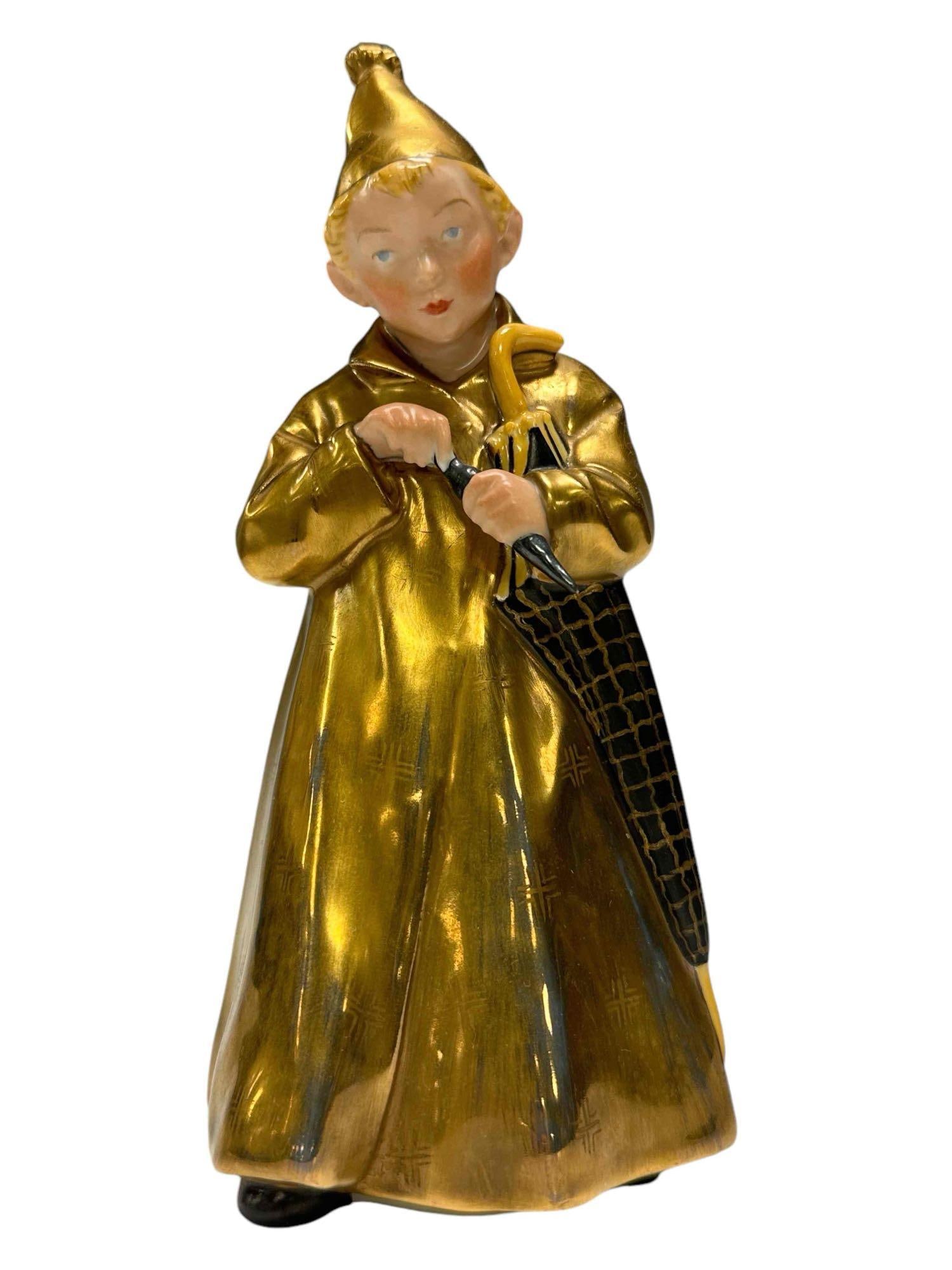 Royal Copenhagen Gilded Porcelain Figurine, The Sandman: Limited figure of a boy in a golden robe clutching a black and gilded umbrella. 1145 and Royal Copenhagen back stamp as shown, see photos, light gild, overall good condition as shown. Measuring approx