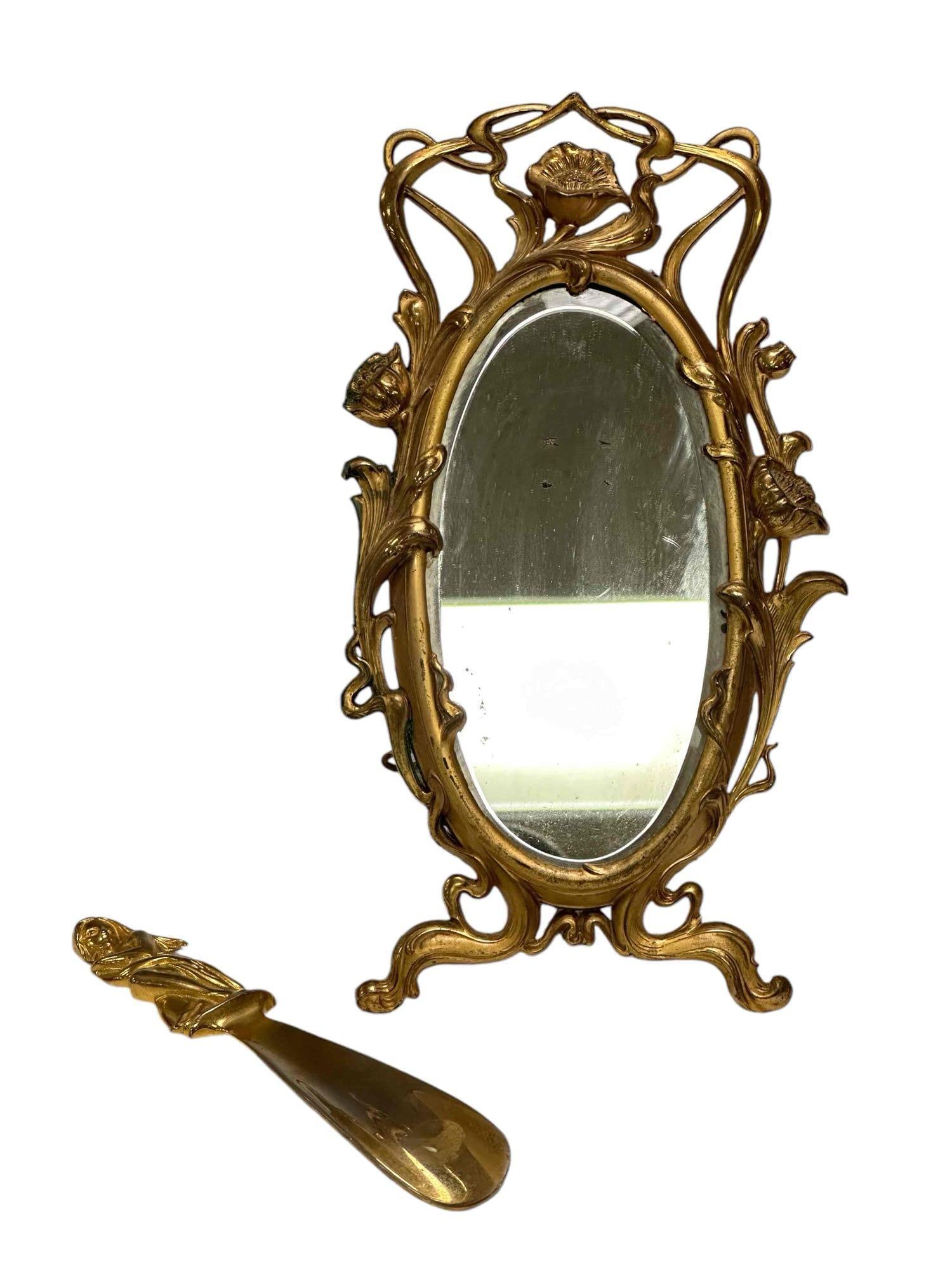 Gilt Bronze Art Nouveau Mirror w/ Bonwit Teller Shoe Horn: Self standing mirror measuring approx 12in tall x 6in wide and a brass Italian figural shoe for BONWIT TELLER as shown with stamp on verso approx 8.5in long