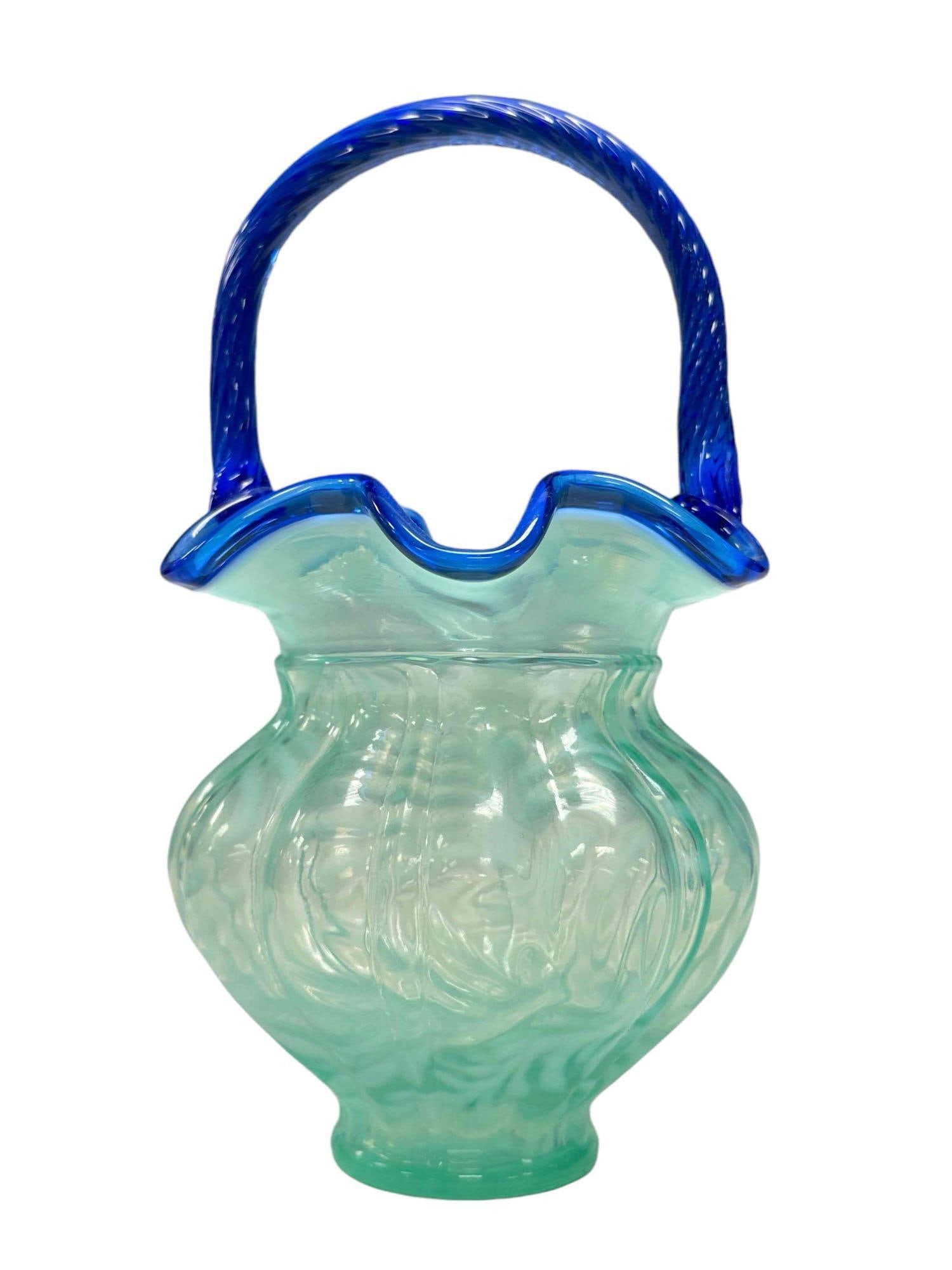 Fenton Daisy and Fern Blue Opal Art Glass Basket: Signed on bottom W.C Fenton with cobalt swirl handle and edge having impressed center stamp which appears to have been missed stamped twice. Measuring approx 9" yall x 5" diameter. Very good as shown,