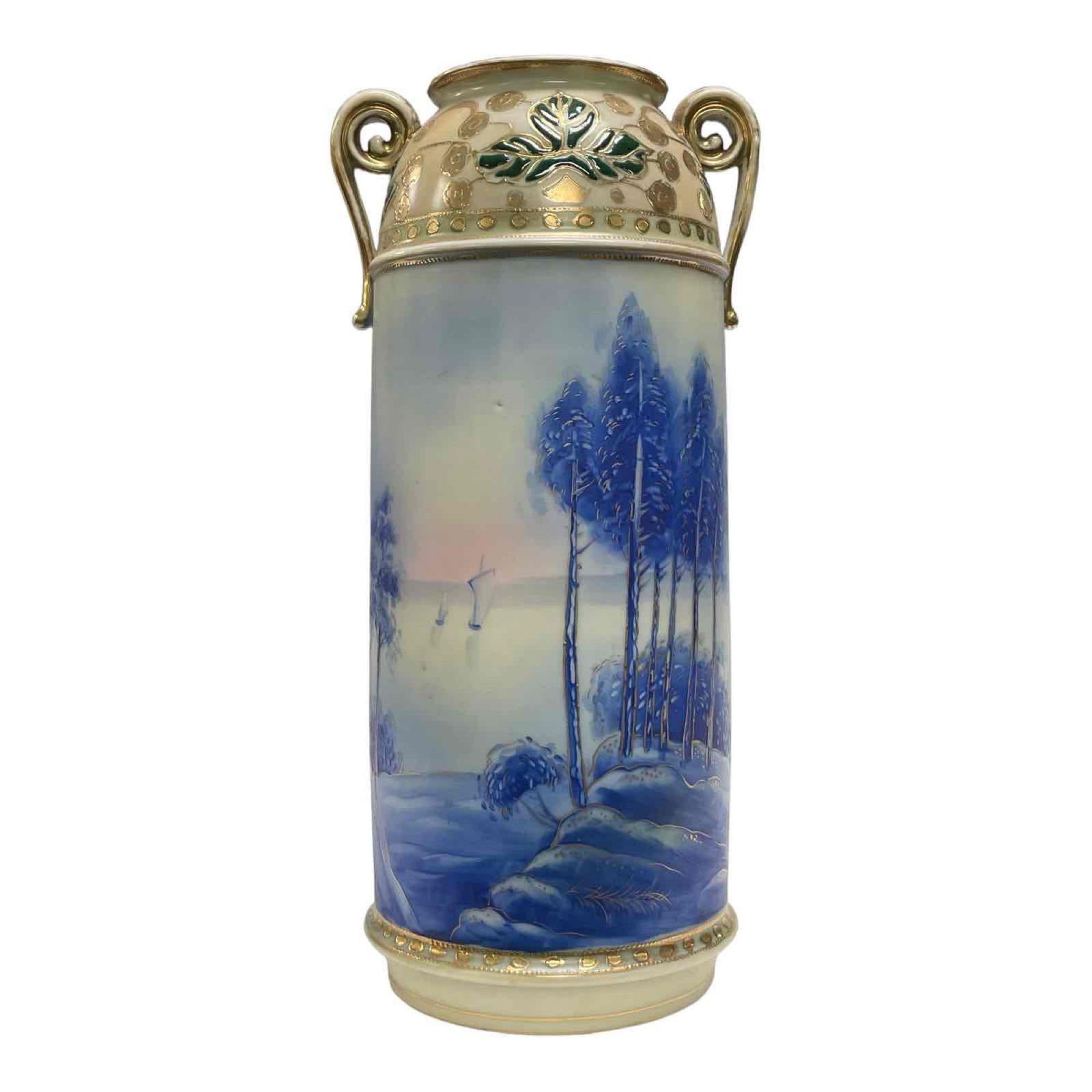 Early Hand Painted Nippon Vase: Early hand painted porcelain vase with partial gold gilt accents present throughout. Cobalt lake landscape with sailboats and treeline. Green stamp mark on bottom as shown. Some gilt wear on double ha