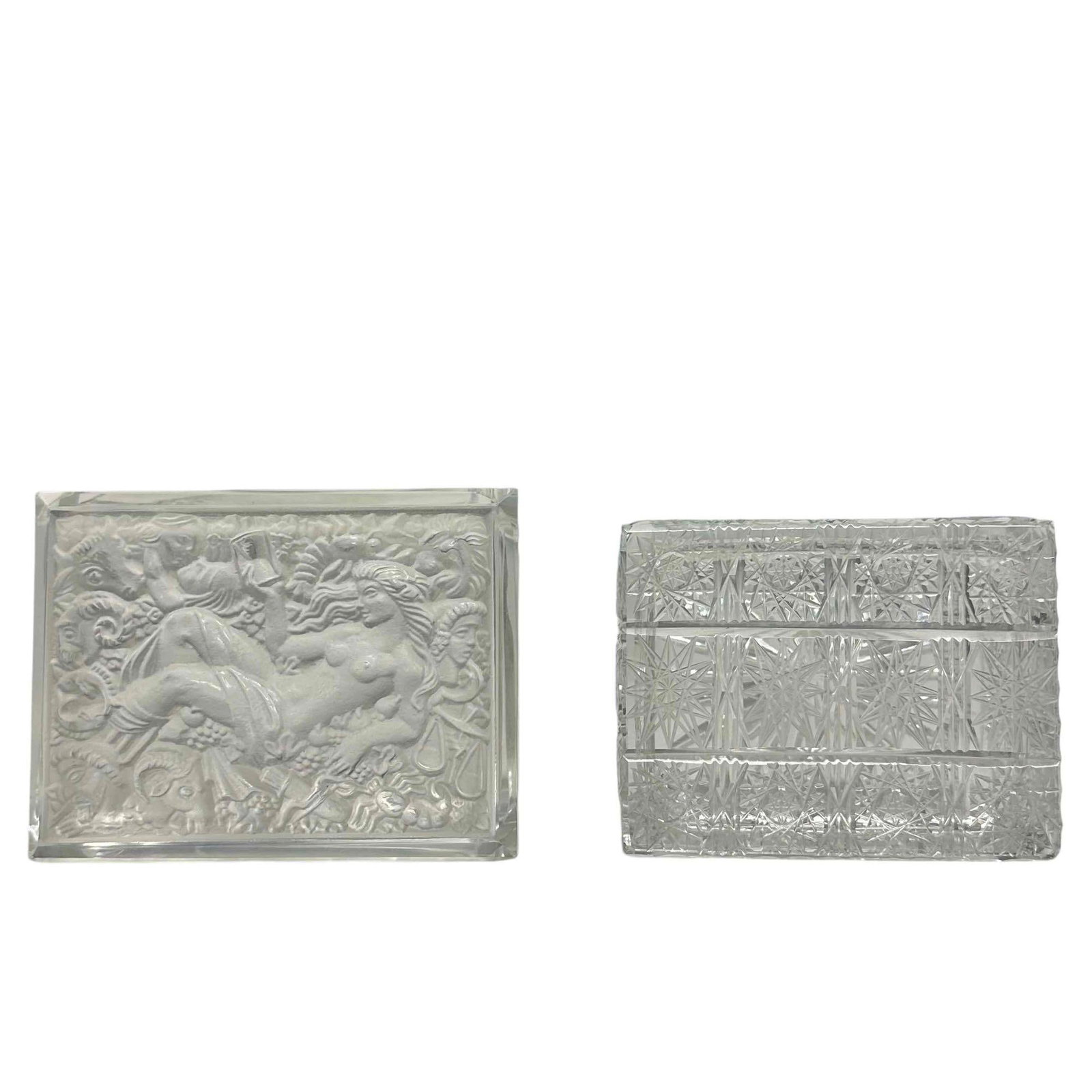 Two Cut Glass and Crystal Lidded Trinket Vanity Boxes: One with high relief frosted lid with nude female surrounded by the Zodiac signs measuring approx 2.25" tall x 5" wide and the cut glass with star and button patterned. Both in good condition.