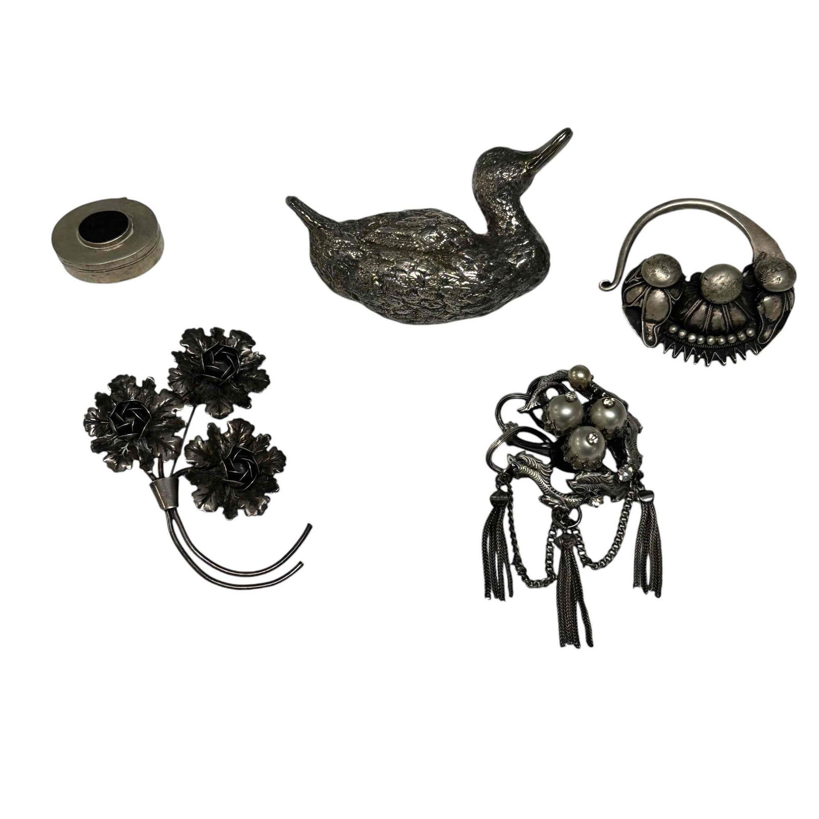 Sterling Silver and Pewter Brooches with Pill Box: Group of sterling includes a small hinge lidded 1" wide pil box, sterling silver duck 3.5" wide, CORO sterling pin brooch and a pewter dragon and rhinestone brooch and one other tribal style pc. See p