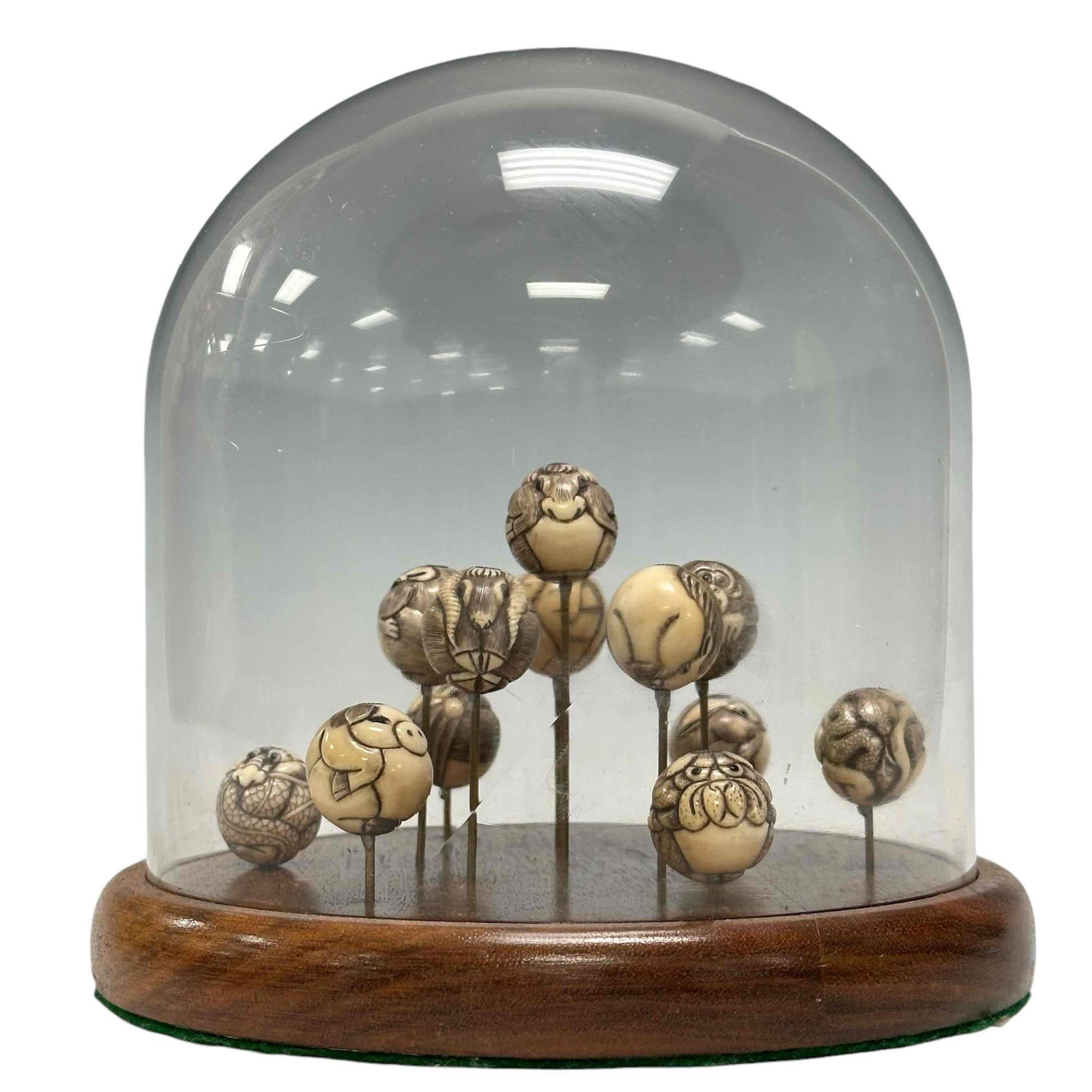 Collection Of (12) Fine Carved Japanese Ojime Beads: A collection of 12 openwork carved NETSUKE style bone /ivor y beads, each a spherical shape and an animals possibly representing the zodiac on the surface. The animals which are depicted on the beads