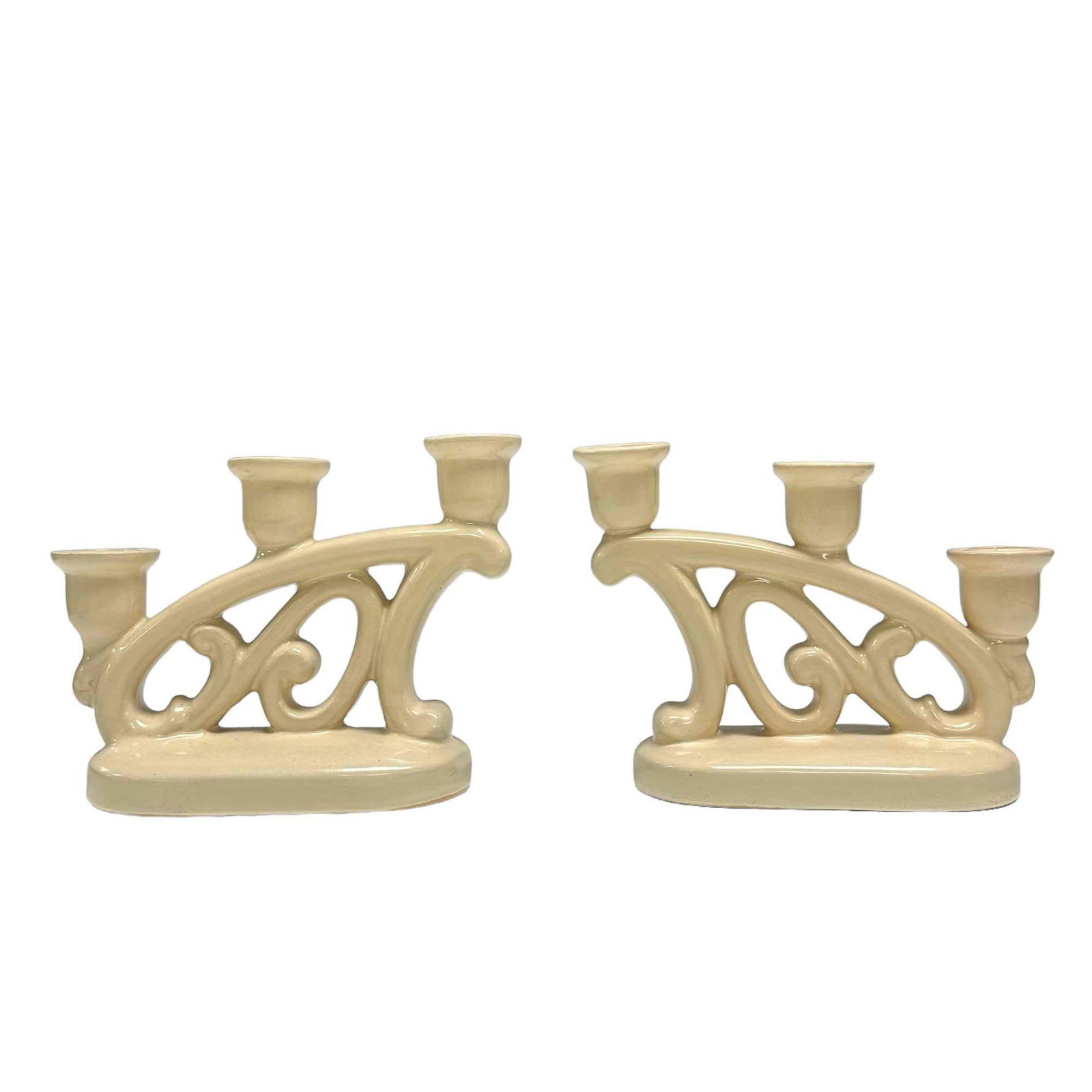 Pair of WELLER Pottery Ivory / Bone Candlesticks: A pair of three light pottery condlesticks in ivory or bone tone by Weller Pottery as shown with impressed script on bottom. Measuring approx 6.5" tall x 8.5" wide. Good condition as shown, early 20th