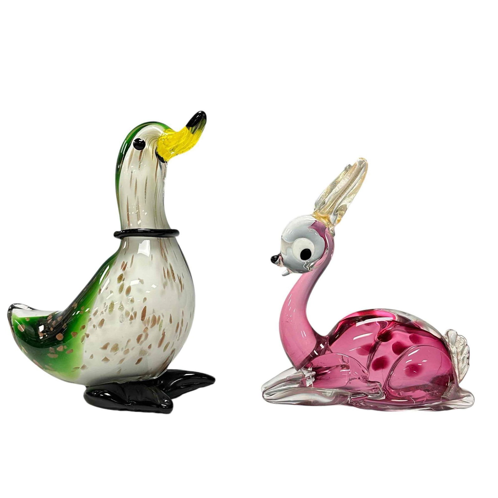 Two Italian Murano Art Glass Animals: Including a cranberry and clear fawn (baby dear) lying down measuring approx 7" tall x 6" wide and a duck approx 8.5" tall x 7.5" wide. Both in good condition as shown, see photos