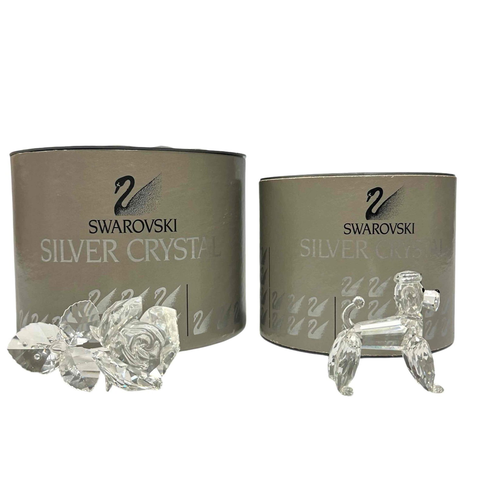 Swarovski Crystal Poodle and Rose Blossom: A clear crystal dog with black nose and eyes. Swarovski swan marked. Part of the Pets Corner theme group. This item has its original box: 5"W x 4"H. Artist: Adi Stocker Issued: 1992 - 1997 Dimensions: