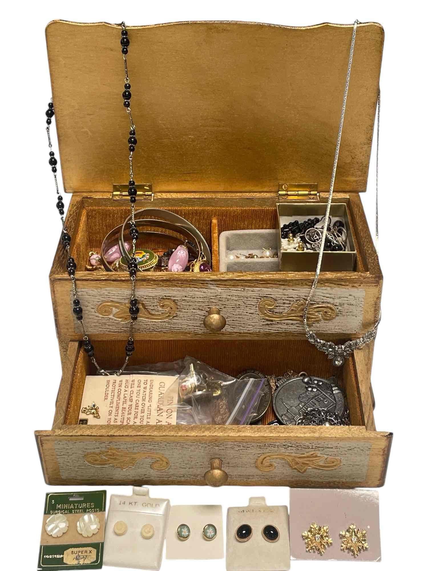 Gold Toned Jewelry Box Filled with Jewelry: Wooden jewelry box filled with assorted jewelry including 14KT gold earrings, 14KT bone carved rose earrings, sterling silver shell inlaid bangle bracelet marked "Mexico." Condition: Missing a piece o