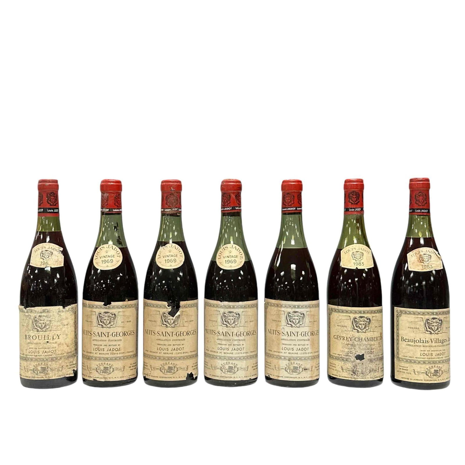 Seven (7) Vintage Collectible Louis Jadot French Bottles: Including 1983 Beaujolais - Villages Jadot, 1983 Gevrey Chambertin, 1983 Brouily, four (4) 1969 NUITS-SAINT-GEORGES. Great collectible and decorative bottle for your wine cellar or French interiors, s