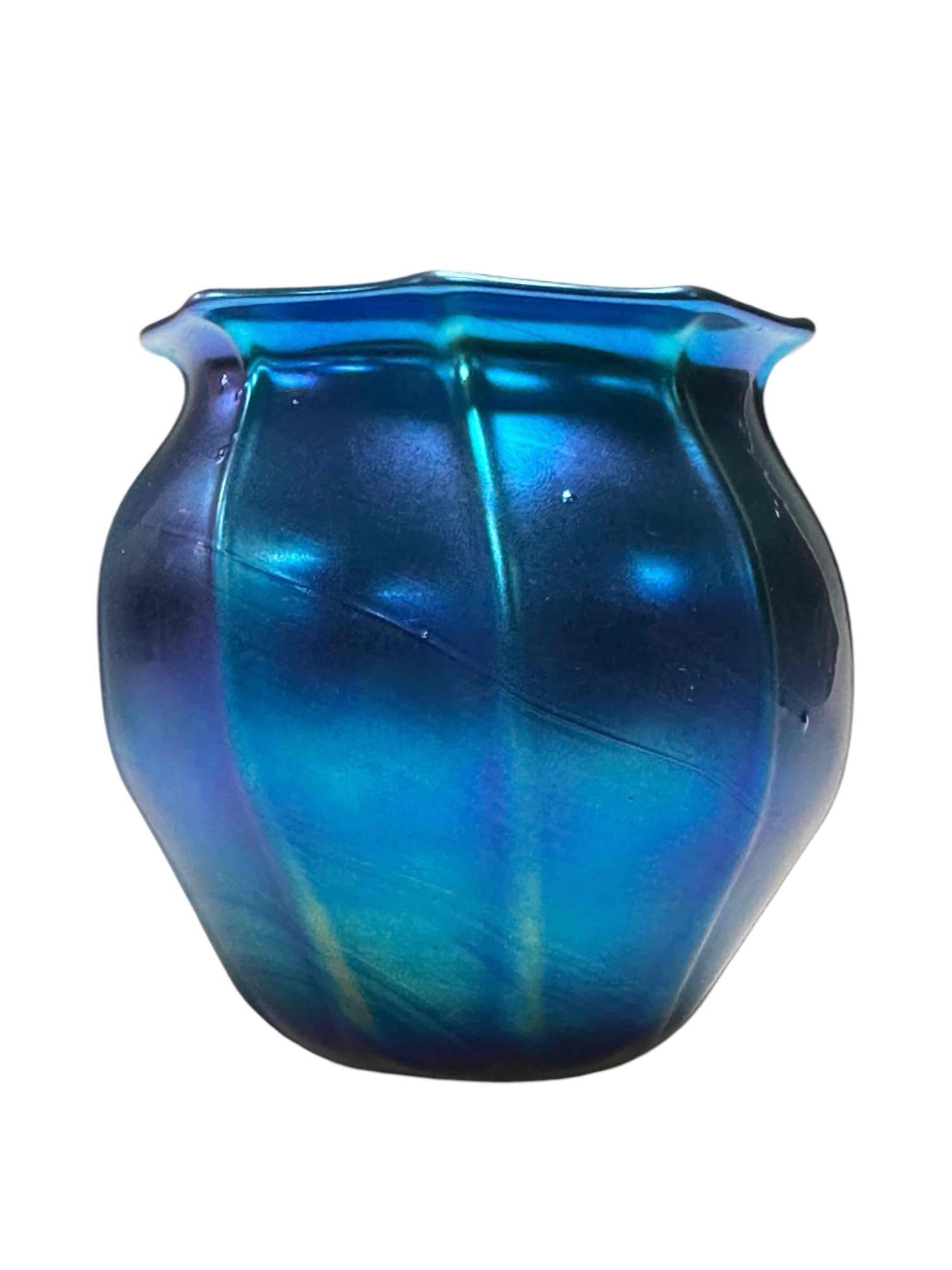 Deep Blue Ribbed Body Art Glass Vase: Unsigned, Loetz style art glass vase with 9 ribs running from top to bottom having a flared, undulating lip. Measuring approx 4" tall x 3.1/2" dia. No issues, very good as shown