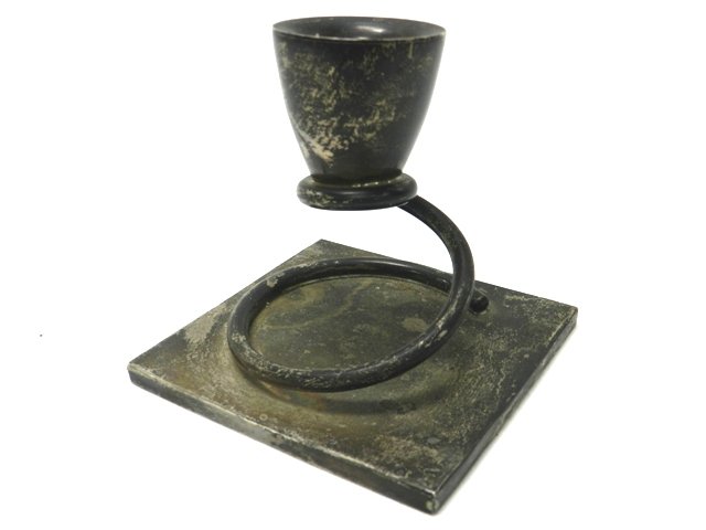 MV Taxco Sterling Deco Candle Stand: Taxco sterling mexican candle stand. Square base with a wire style wrap to an allied single candle stand. Unpolished, hall marks MV Taxco and in good condition. Approx 3". Approx 6.5 troy ounce.