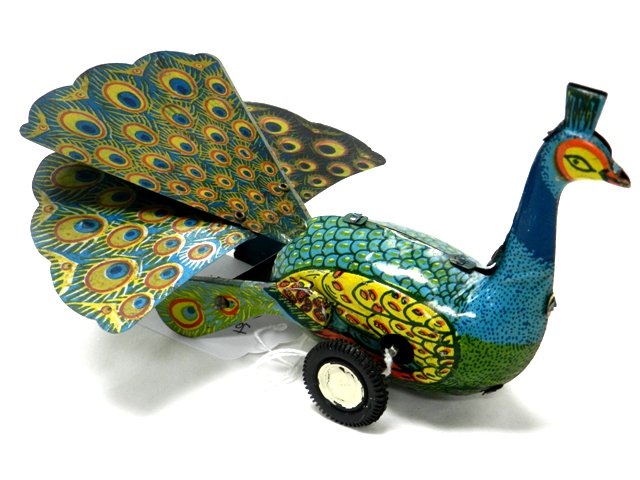 Japan Peacock Tin Wind-Up: Japan tin wind up of a peacock with flared tail feather with good paint and working. Approx 7" in size. Near mint circa 1950All Toys Come from A Collector in Cleveland Area. Premier Auction Galleries 