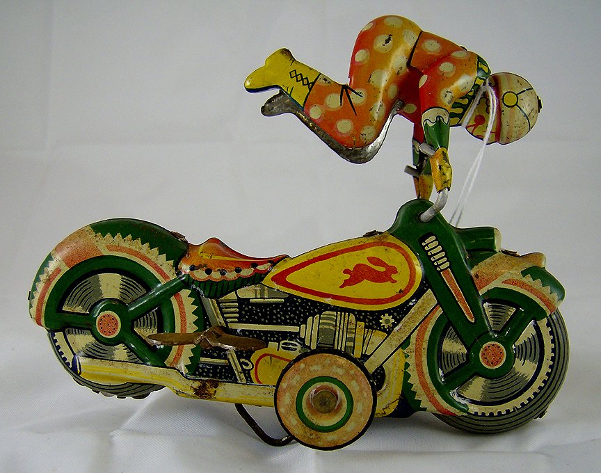 Flip Over Clown on Motorcycle: Circa 1950's. Tin litho made in Japan. All complete original and working. Good condition.