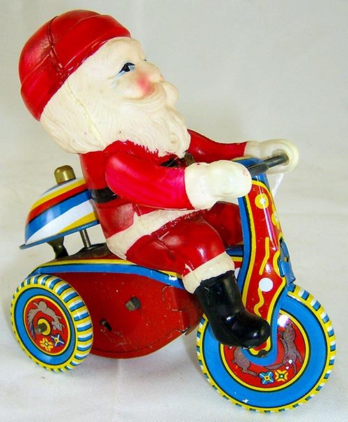 Tin Windup Santa Claus on Trike: Circa 1950's. All original complete and working. Made in Japan. Great color. Mint condition.