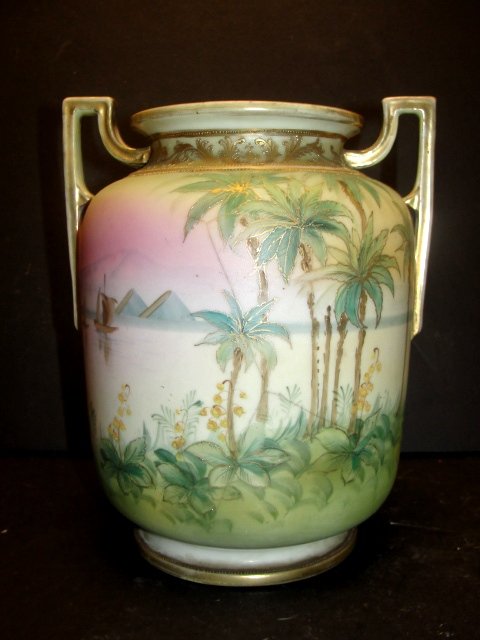Hand Painted Nippon Scenic Double Handle Vase: with stylized gilt and mountain scene with lake and trees. Condition wear to gilt on handle's, crows foot hair line crack on one side. H. 8 3/4'' Dia. 7''