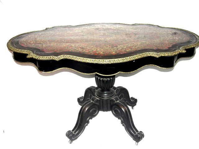 French Antique Boulle And Bronze Center Table: Having heavy carved pedestal base in black ebonized / paint tortoise shell and brass inlaid top. Top turtle shaped with scalloped apron and ormolu trim. Condition apron has some splits and missing ven