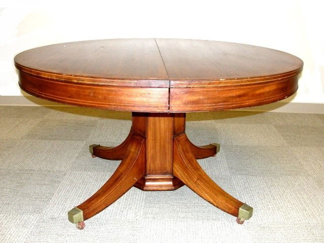 Mahogany String Inlaid Table With Six Chairs: Hepplewhite style 1920's Table being 55'' round and 30'' high, having string inlays on top, apron and pedestal with 4 10'' Leaves, will accept more leaves. Comes with six inlaid original dinning chair