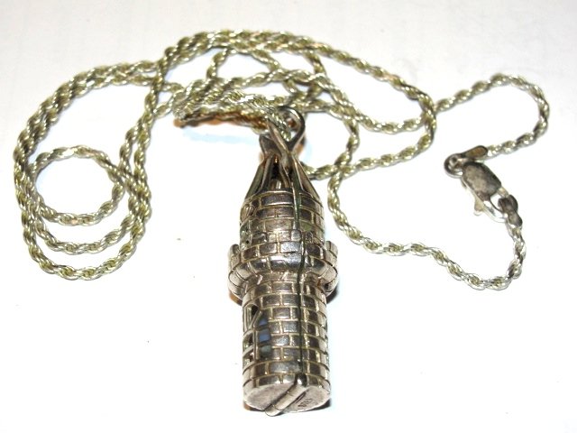Sterling Necklace With Castle Looking Pill Box: Pill box in the form of a castle that opens to store pills in. On a 24'' sterling chain, pill box 1 1/2'' x 1/2''. Condition very good. 19 grams.